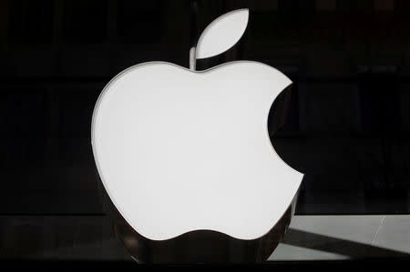 FILE PHOTO: The logo of Apple is seen at a store in Zurich, Switzerland January 3, 2019. REUTERS/Arnd Wiegmann/File Photo