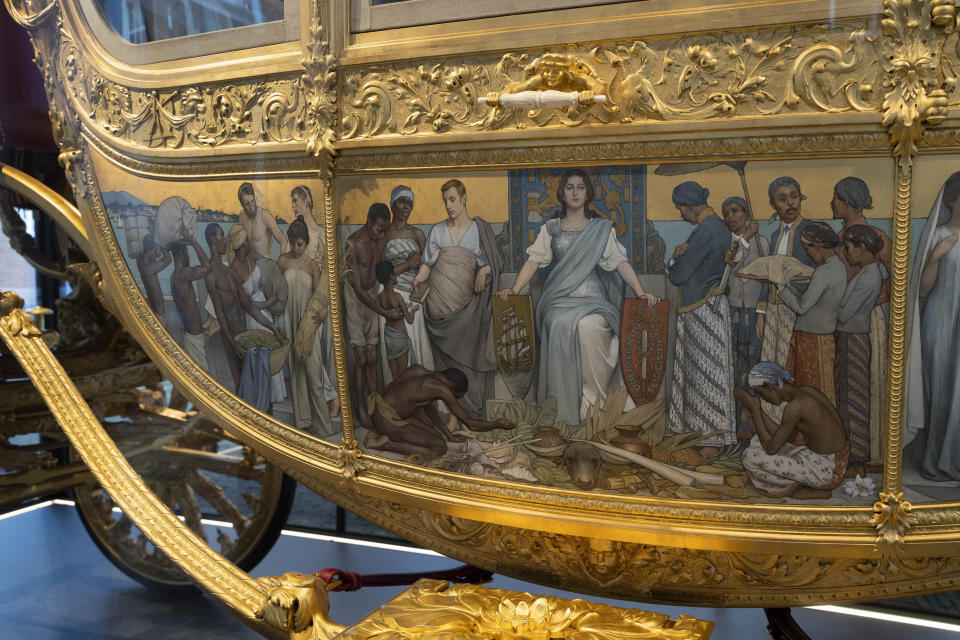 FILE - The controversial painting on the Golden Carriage is seen as the carriage is displayed at the Amsterdam Museum in Amsterdam in this Jan. 19, 2022 file photo. The Dutch king ruled out Thursday, Jan. 13, 2022, using in the near future the royal family's Golden Carriage, one side of which is decorated with a painting that has drawn fire from critics who say it glorifies the Netherlands' colonial past, including its role in the global slave trade. The Netherlands is expected to issue a national apology for its brutal slavery past when Dutch officials visit their former Caribbean colonies in late Dec. 2022.(AP Photo/Peter Dejong, File)