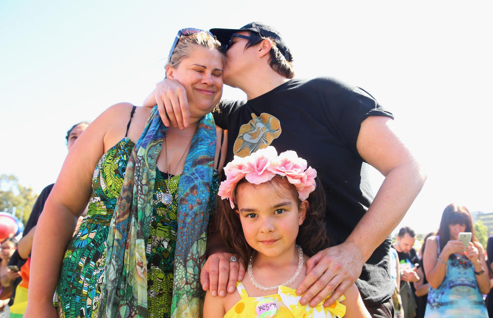 Mathilda Bowman, 5, looks on as her mothers, Kate Bowman and Melinda Voigt, each place a hand on her shoulder in Sydney. (Photo: Don Arnold via Getty Images)