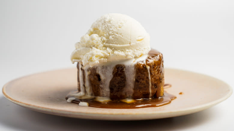 Sticky toffee pudding topped with ice cream