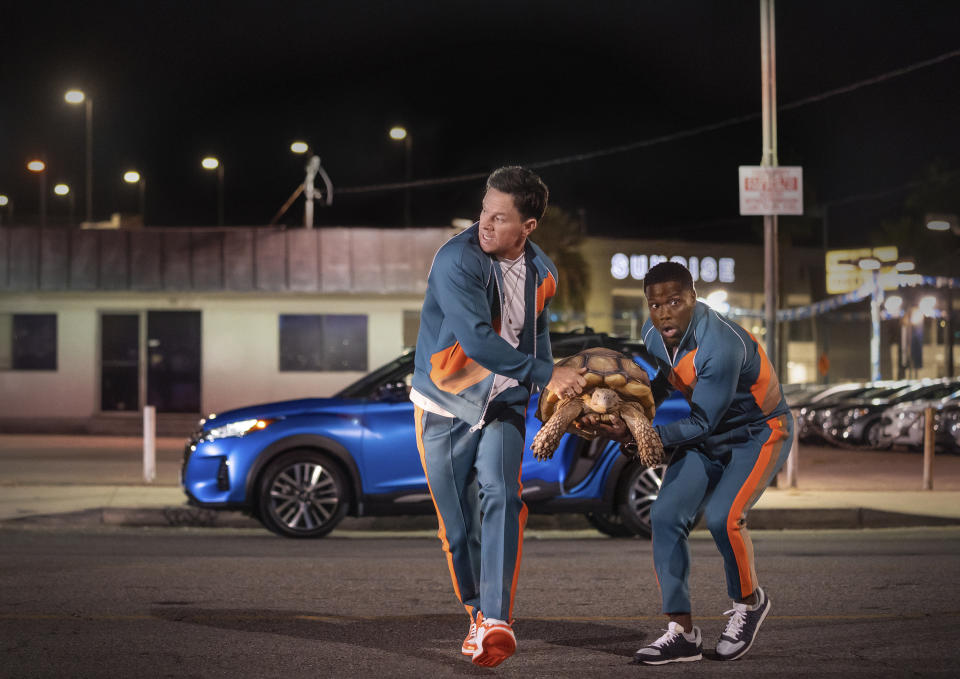 This image released by Netflix shows Mark Wahlberg, left, and Kevin Hart in "Me Time." (Saeed Adyani/Netflix via AP)