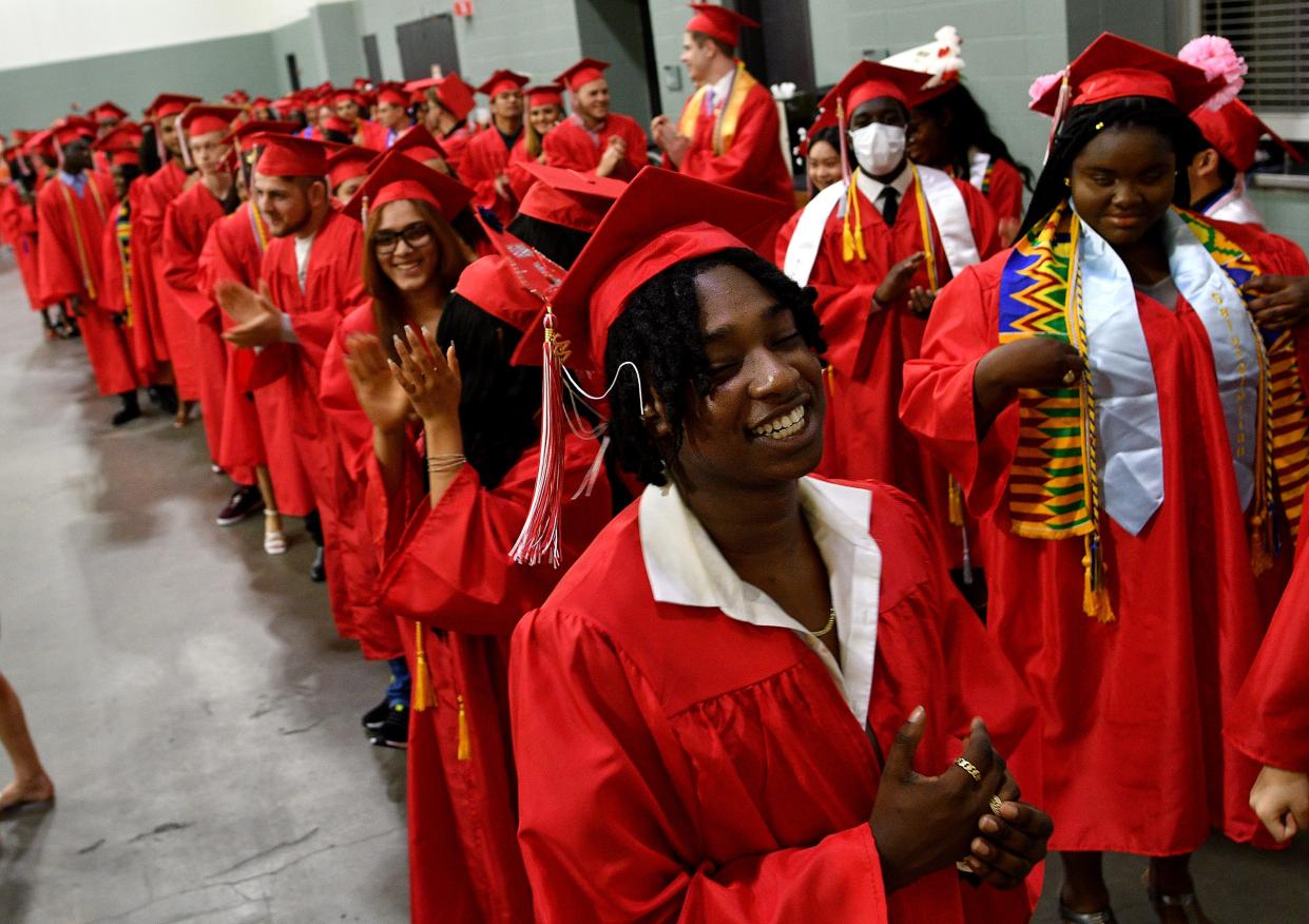 Michael Abaidoo cheers along as the South High Community School graduates line up for procession to graduation at the DCU center on Wednesday.