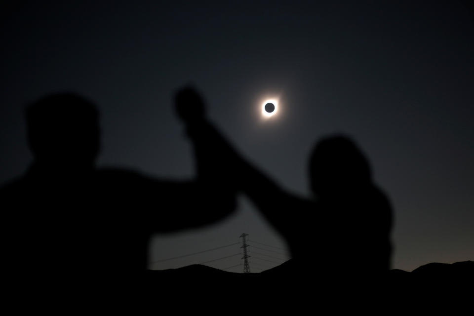 People react while observing a solar eclipse at Incahuasi, Chile, July 2, 2019. (Photo: Juan Jose Gonzalez Galaz/Reuters)