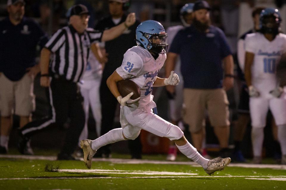 Springfield running back Connor Dye carries the ball for the Millers. The Springfield Millers defeated the Willamette Wolverines 42-34 at Willamette High School in Eugene Friday, Oct. 14, 2022. 