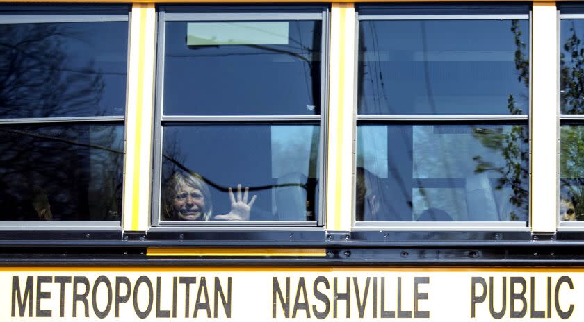 A child weeps while on the bus leaving The Covenant School following a mass shooting