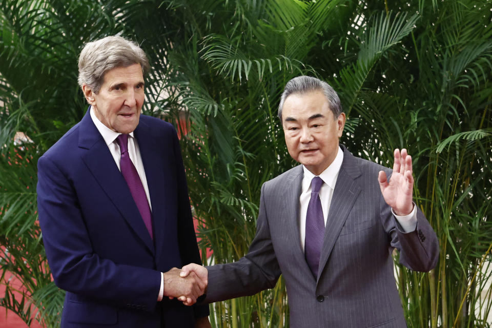 U.S. Special Presidential Envoy for Climate John Kerry, left, and Chinese top diplomat Wang Yi shake hands before a meeting at the Great Hall of the People in Beijing Tuesday, July 18, 2023. (Florence Lo/Pool Photo via AP)