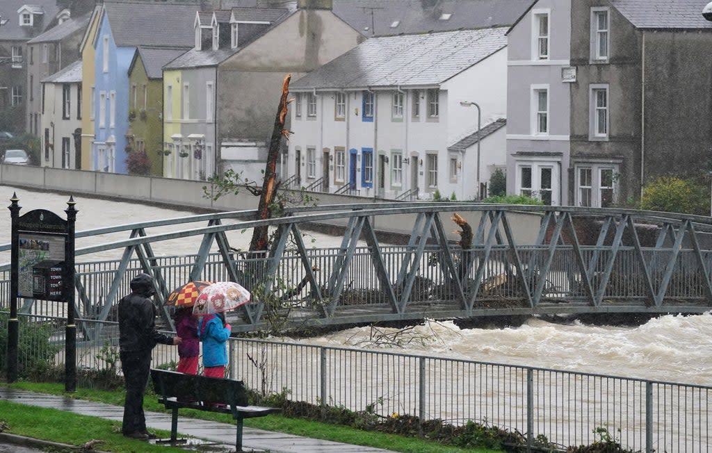 Residents watch rising water levels in Cockermouth (Owen Humphreys/PA) (PA Wire)