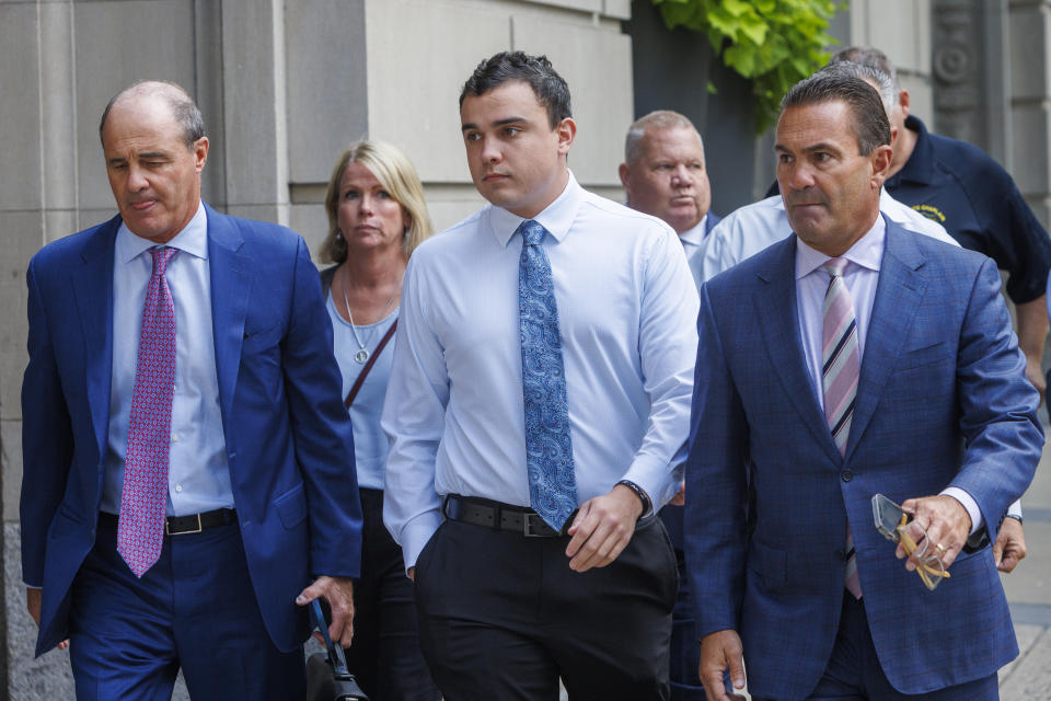 FILE - Philadelphia police officer Mark Dial, center, arrives at the Juanita Kidd Stout Center for Criminal Justice in Philadelphia, Sept. 19, 2023, with attorneys for a bail hearing. Brian McMonigle is at left and at right is Fortunato Perri. A judge has reinstated all charges, including a murder count, against the former officer who shot and killed a driver through a rolled-up car window — a confrontation police initially described as the officer shooting the driver after he lunged at him with a knife outside the car. Common Pleas Court Judge Lillian Ransom ruled Wednesday, Oct. 25, 2023 after a hearing that the facts of the case should be established at a trial. (Alejandro A. Alvarez/The Philadelphia Inquirer via AP, File)