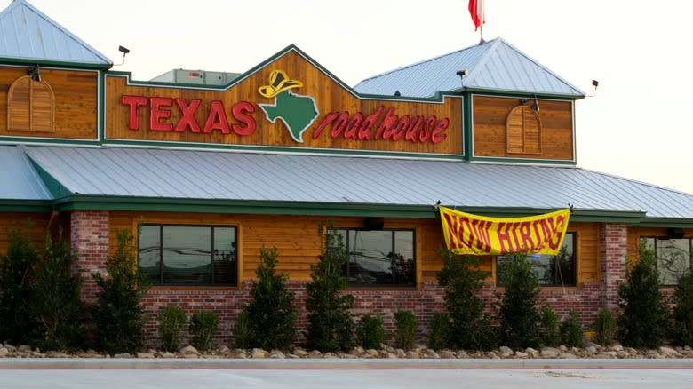 Texas Roadhouse with now hiring signage