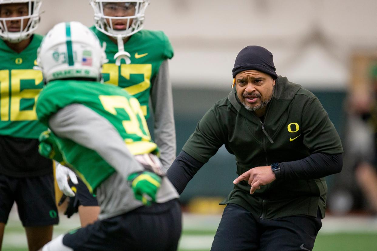 Oregon cornerbacks coach Demetrice Martin works with players April 14, 2022, during practice in Eugene, Ore.