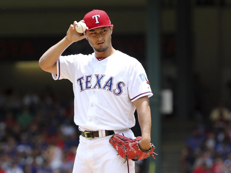 Texas Rangers starting pitcher Yu Darvish adjusts his cap as he works the first inning of a baseball game against the Los Angeles Angels in Arlington, Texas, Sunday, July 9, 2017.