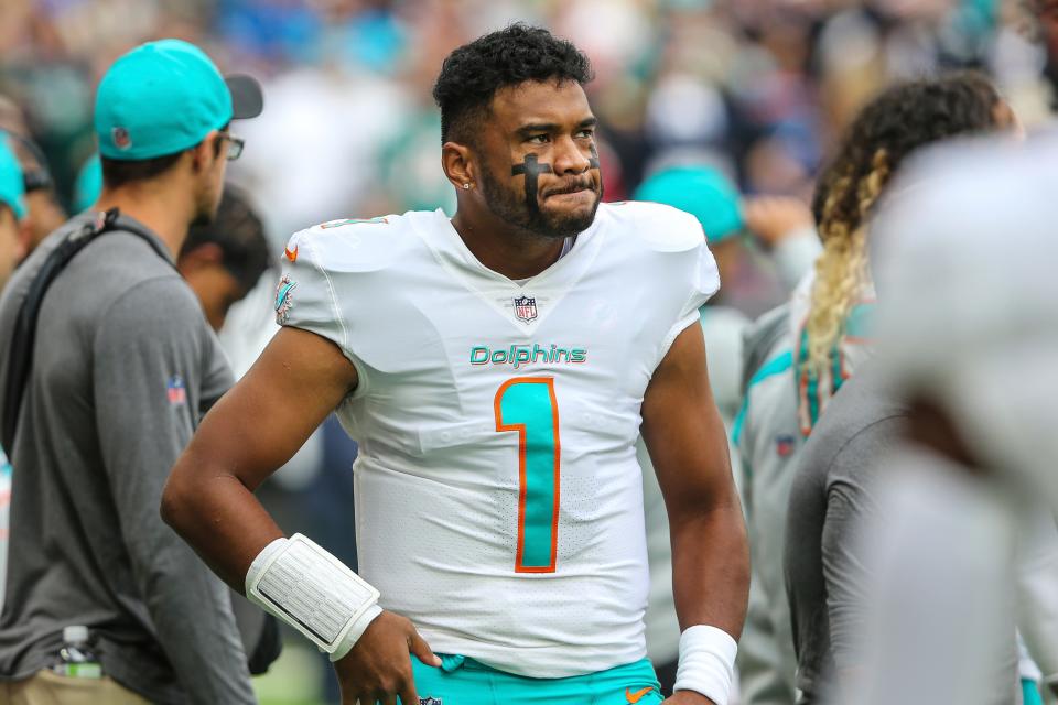 Miami Dolphins quarterback Tua Tagovailoa walks the sideline before a game against the Jacksonville Jaguars