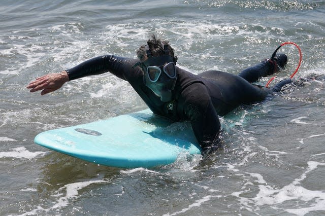 A protester takes to the water