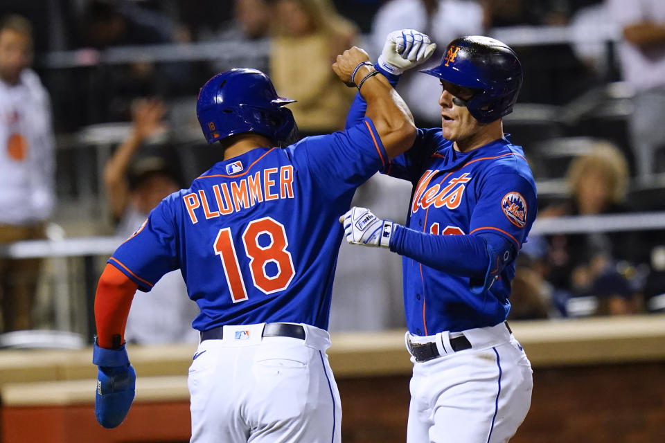 New York Mets' Mark Canha, right, celebrates with Nick Plummer after they scored on a two-run home run by Canha during the fifth inning of the team's baseball game against the Milwaukee Brewers on Thursday, June 16, 2022, in New York. (AP Photo/Frank Franklin II)