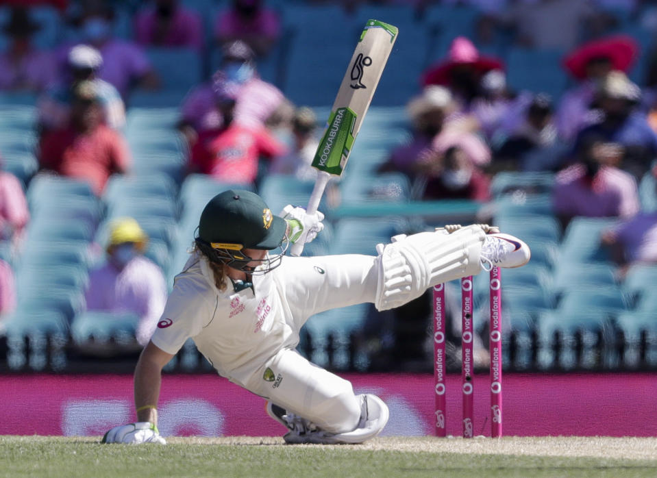 Australia's Will Pucovski falls while batting during play on day three of the third cricket test between India and Australia at the Sydney Cricket Ground, Sydney, Australia, Saturday, Jan. 9, 2021. (AP Photo/Rick Rycroft)