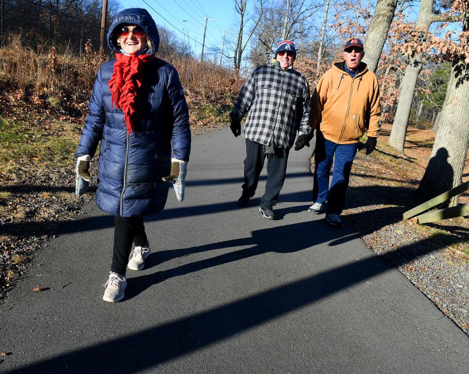 Pat Pingeton, 75, left, of Worcester, enjoys a brisk walk at Quinsigamond State Park in Worcester with her husband, Jack, center, and friend George Dubois.