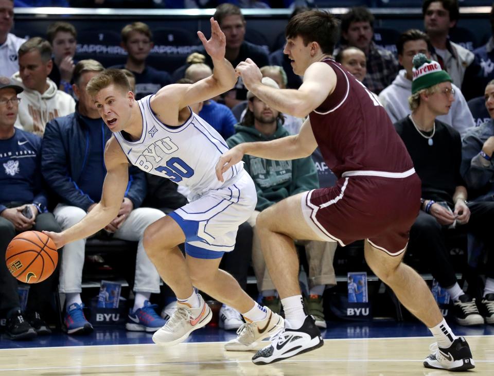 Brigham Young Cougars guard Dallin Hall (30) dribbles around Bellarmine Knights forward Langdon Hatton (12) during a men’s basketball game at the Marriott Center in Provo, on Friday, Dec. 22, 2023. | Kristin Murphy, Deseret News