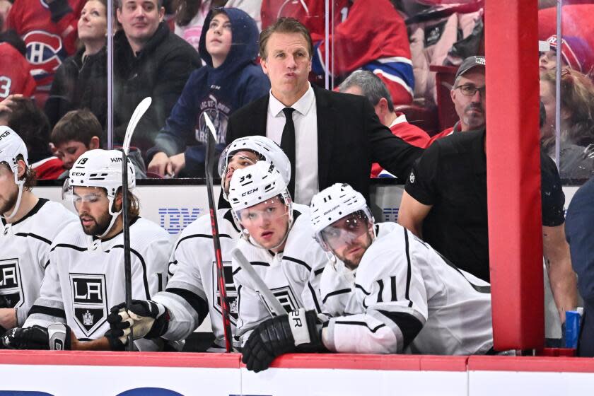 Jim Hiller stands behind the bench during a game between the Kings and Montreal Canadiens.