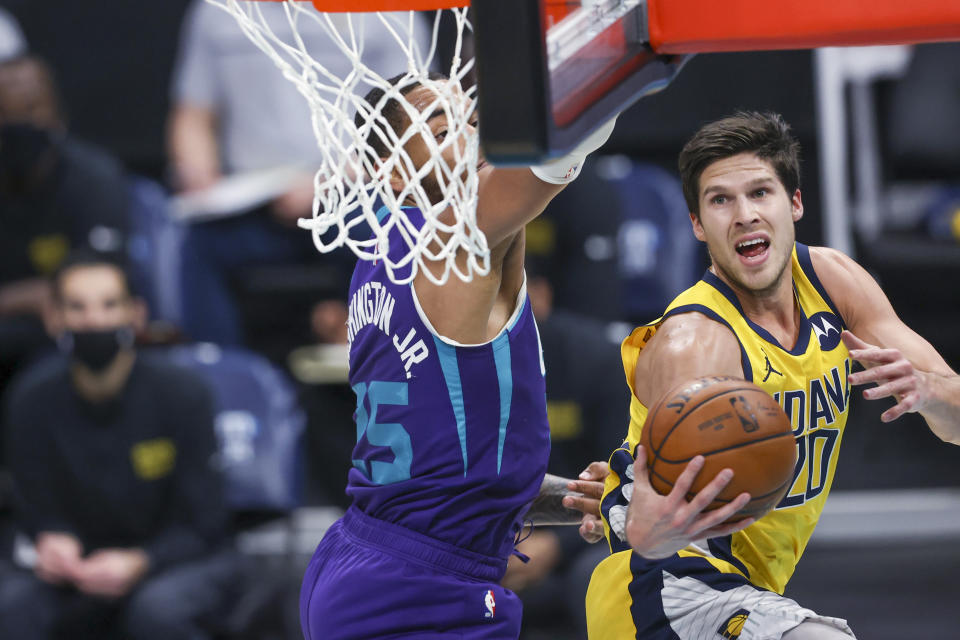 Indiana Pacers forward Doug McDermott, right, drives to the basket against Charlotte Hornets forward P.J. Washington during the first half of an NBA basketball game in Charlotte, N.C., Wednesday, Jan. 27, 2021. (AP Photo/Nell Redmond)