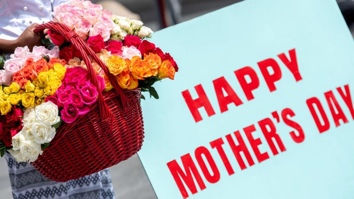 <div>NEW YORK, NEW YORK - MAY 09: A woman holds a large basket of flowers next to a "happy Mothers Day" sign in Washington Square Park on Mothers Day amid the Coronavirus pandemic on May 09, 2021 in New York City. People and families enjoy Mothers Day in anticipation of coronavirus restrictions being lifted on May 19th according to an announcement by New York Governor Andrew Cuomo last week. (Photo by Alexi Rosenfeld/Getty Images)</div>