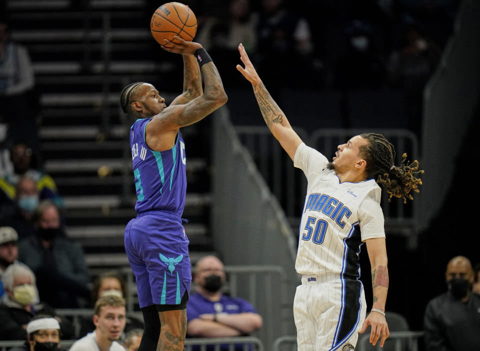 Charlotte Hornets guard Terry Rozier (3) shoots over Orlando Magic guard Cole Anthony (50) during the first half of an NBA basketball game on Friday, Jan. 14, 2022, in Charlotte, N.C. (AP Photo/Rusty Jones)