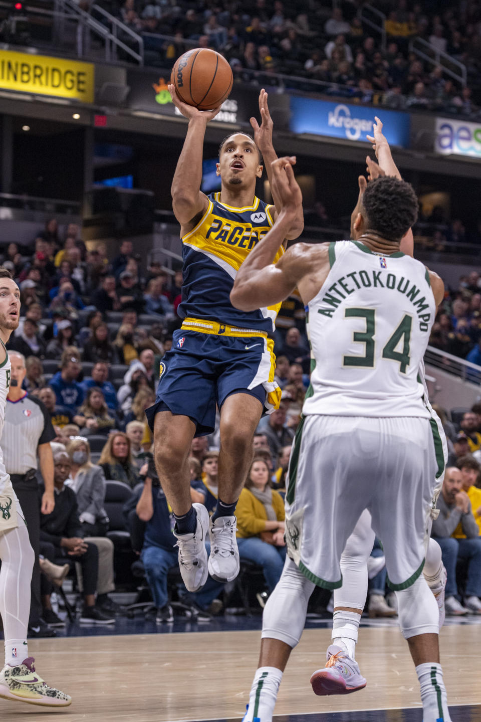 Indiana Pacers guard Malcolm Brogdon (7) drives the ball toward the basket during the first half of an NBA basketball game against the Milwaukee Bucks in Indianapolis, Sunday, Nov. 28, 2021. (AP Photo/Doug McSchooler)