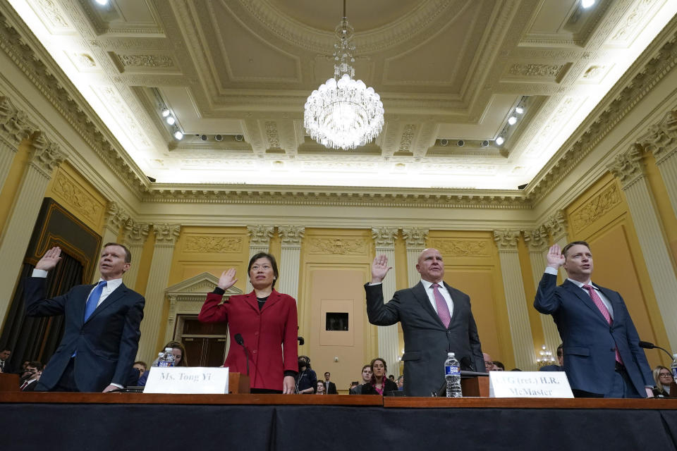 Scott Paul, Tong Yi, H. R. McMaster and Matt Pottinger stand and raise their hands to be sworn in.