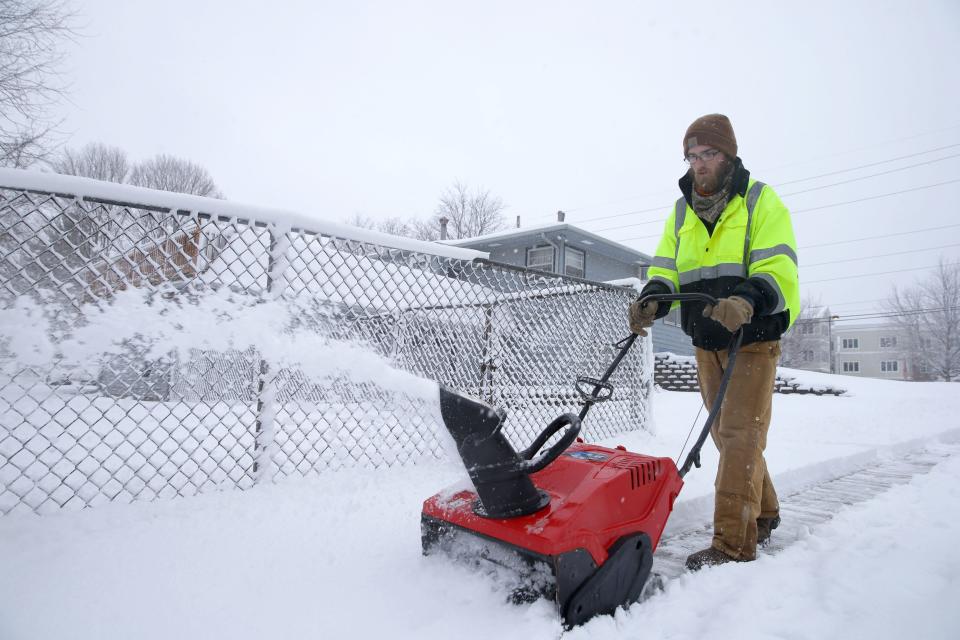 Hunter Florke uses a snowblower to clear snow off of a sidewalk near Benton Street Tuesday, Jan. 9, 2024 in Iowa City, Iowa.