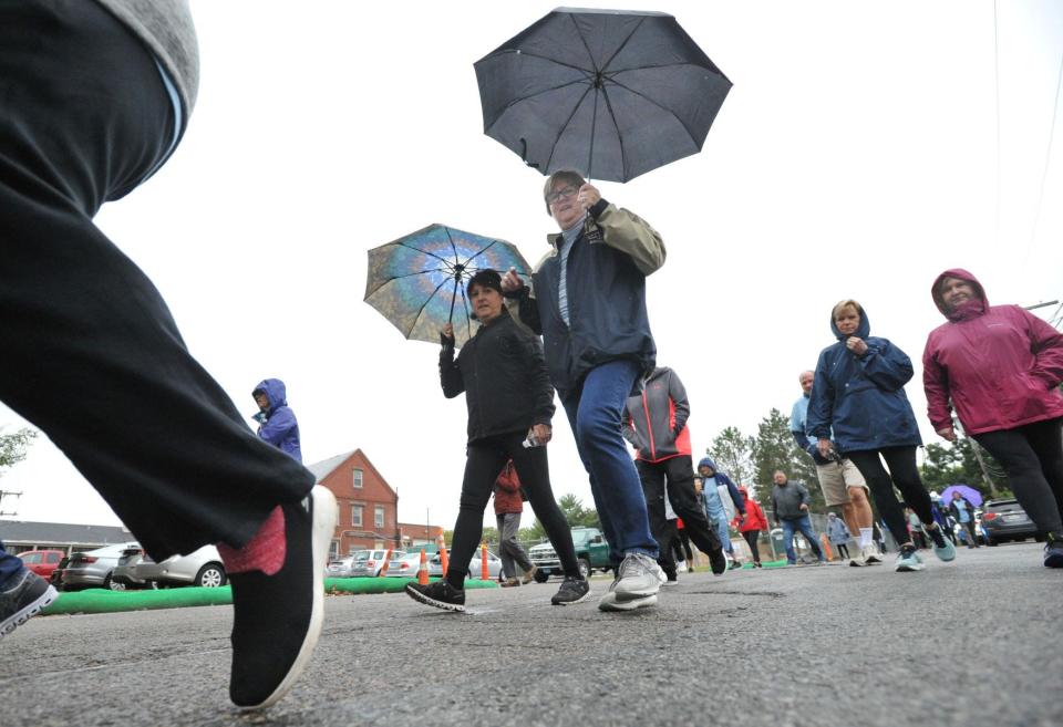 Walkers are prepared for the rain as they head out for the Milton Council on Aging's Fit for Life Walk hosted by Milton Boot Camp to benefit the council, Saturday, Oct. 1, 2022.