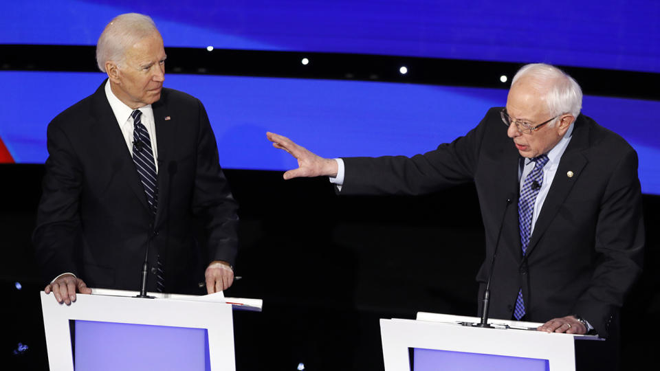 Former Vice President Joe Biden, left, watches as Sen. Bernie Sanders, I-Vt., answers a question during Tuesday's Democratic presidential primary debate in Des Moines. (AP Photo/Patrick Semansky)