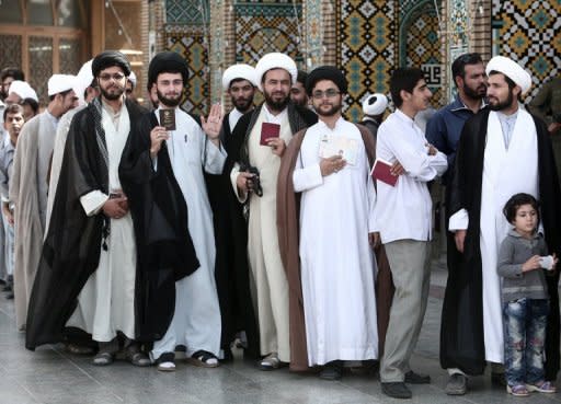 Iranian clergymen wait to vote in the first round of the presidential elections in the Islamic Republic at a polling station in the holy city of Qom, on June 14, 2013. Moderate cleric Hassan Rowhani, bolstered by a late surge in support from suppressed Iranian reformists, took an early lead in the presidential election to find a successor to Mahmoud Ahmadinejad, initial results showed Saturday