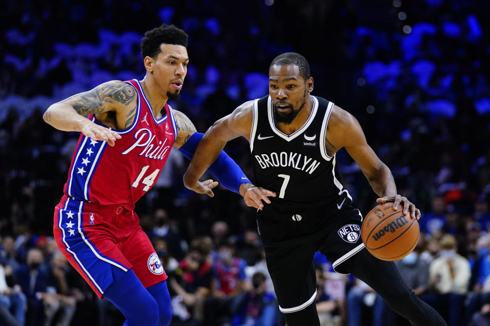 Brooklyn Nets' Kevin Durant, right, dribbles against Philadelphia 76ers' Danny Green during the first half of an NBA basketball game, Friday, Oct. 22, 2021, in Philadelphia. (AP Photo/Matt Slocum)