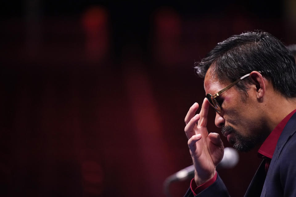 Manny Pacquiao, of the Philippines, listens at a news conference after his loss to Yordenis Ugas, of Cuba, in a welterweight championship boxing match Saturday, Aug. 21, 2021, in Las Vegas. (AP Photo/John Locher)