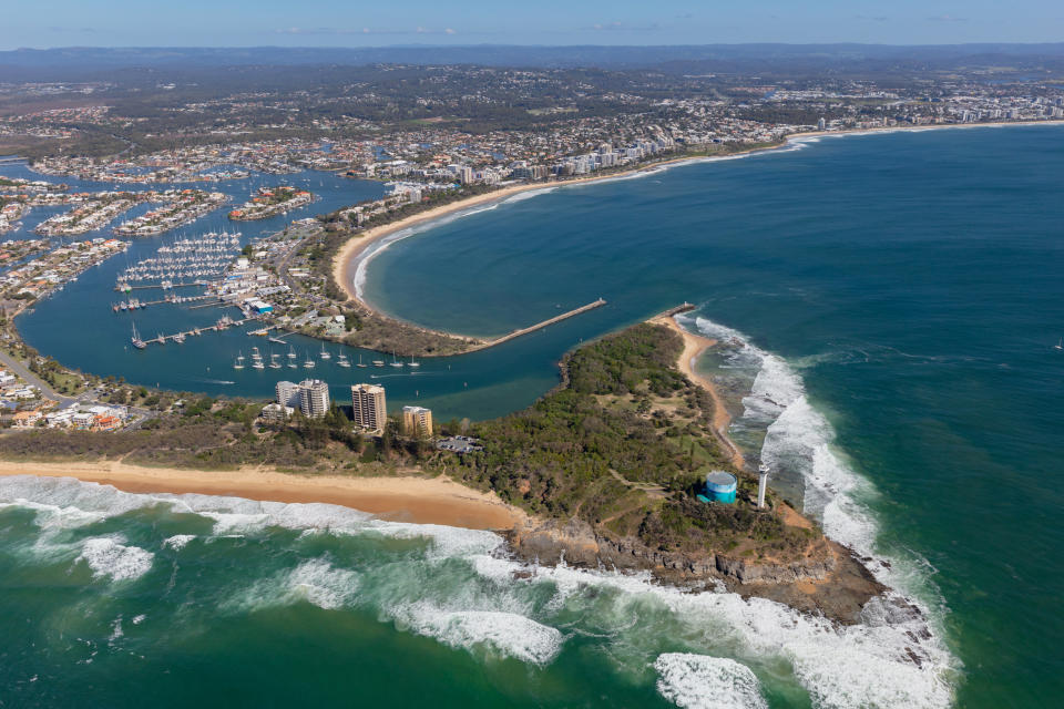 Bright summers day aerial view of coastal area. Port Cartwright provides a sheltered bay for many pleasure boats on the Sunshine Coast, as well sandy surf beaches for residents and holiday makers.