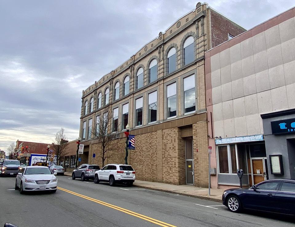 A local dentist plans to build 28 apartments in this three-story, vacant building downtown.