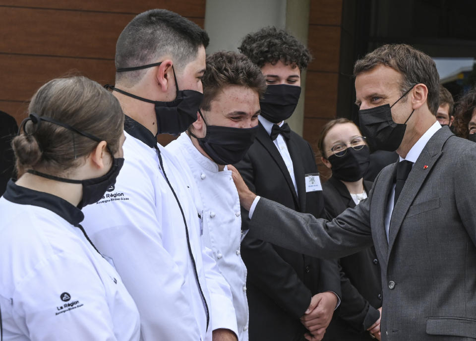 French President Emmanuel Macron talks with cooking students, Tuesday June 8, 2021 at the Hospitality school in Tain-l'Hermitage, southeastern France. (Philippe Desmazes, Pool via AP)