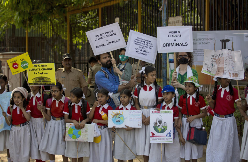 Adults stand in solidarity with Indian students in a climate protest in Hyderabad, India, Friday, March 15, 2019. Students in more than 80 countries and territories worldwide plan to skip class Friday in protest over their governments' failure to act against global warming. The coordinated 'school strike' was inspired by 16-year-old activist Greta Thunberg, who began holding solitary demonstrations outside the Swedish parliament last year. (AP Photo/Mahesh Kumar A.)