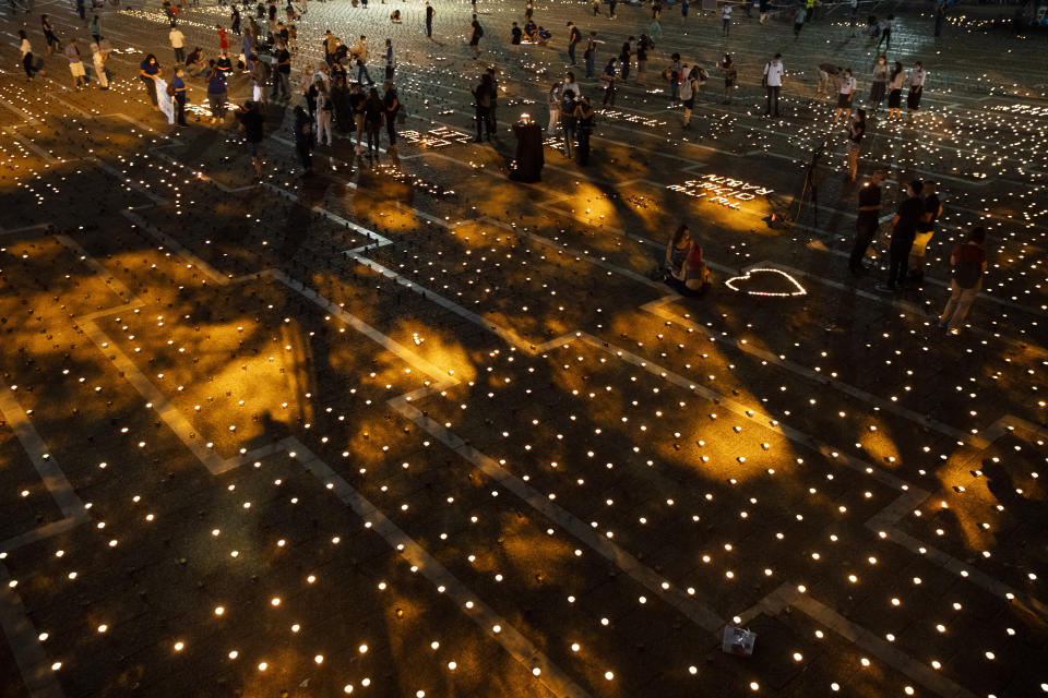 Israelis light memorial candles on the 25th anniversary of the assassination of Israeli Prime Minister Yitzhak Rabin, at Rabin Square, Tel Aviv, Israel, Thursday, Oct. 29, 2020. (AP Photo/Oded Balilty)