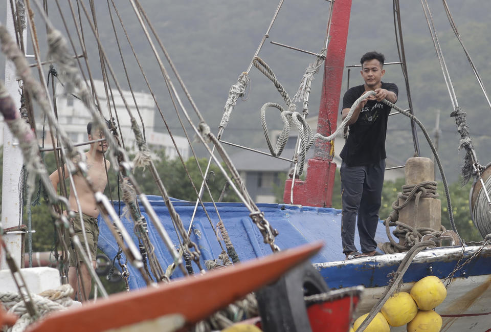 A fisherman fastens a boat as Typhoon Mawar approaches to Taiwan in Yilan County, eastern coast of Taiwan, Tuesday, May 30, 2023. Typhoon Mawar lashed Taiwan's eastern coast on Tuesday with wind, rains and large waves but largely skirted the island after giving a glancing blow to the northern Philippines. (AP Photo/Chiang Ying-ying)