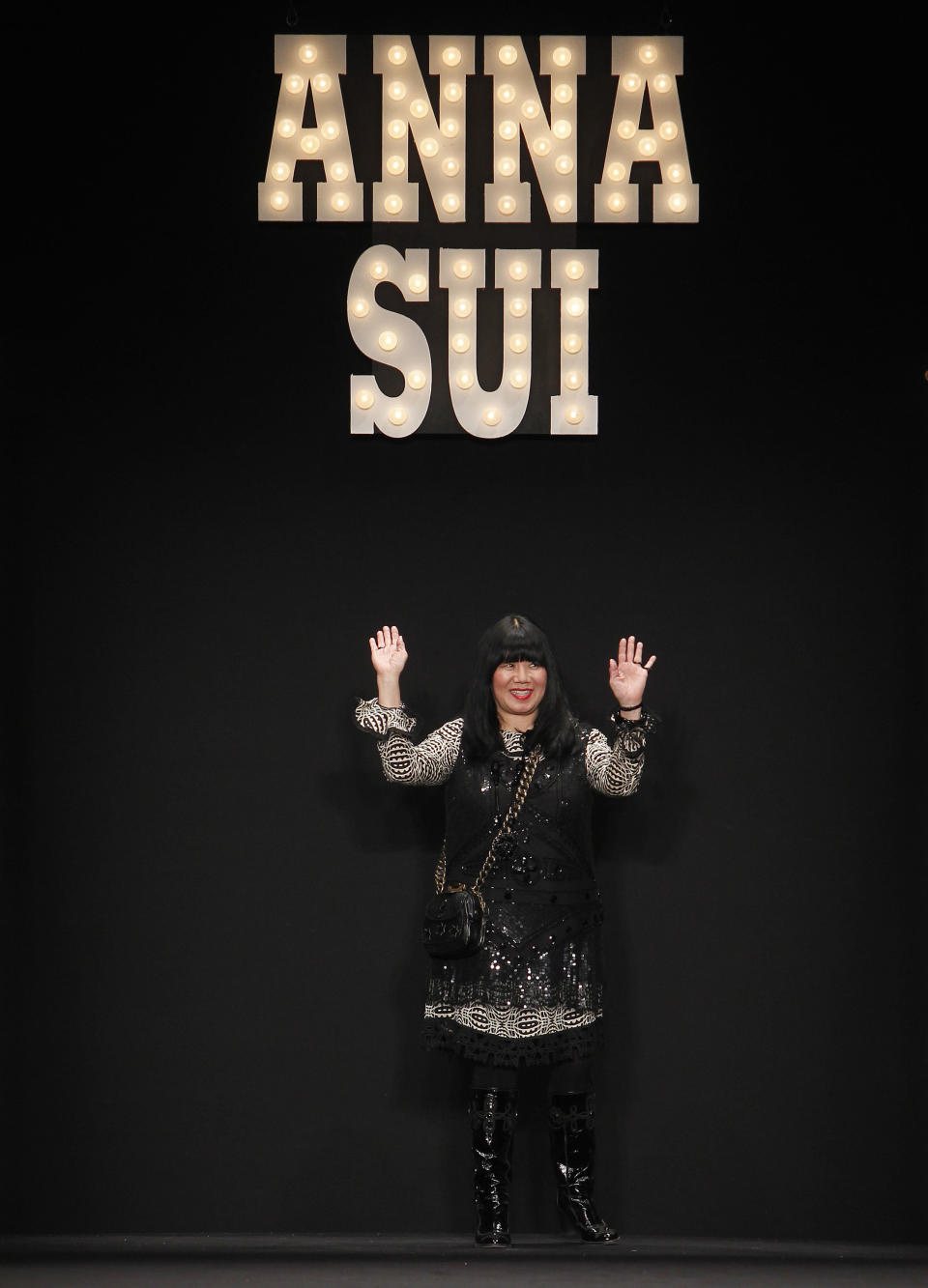 Designer Anna Sui acknowledges the audience after her Fall 2013 collection show during Fashion Week, Wednesday, Feb. 13, 2013 in New York. (AP Photo/Jason DeCrow)