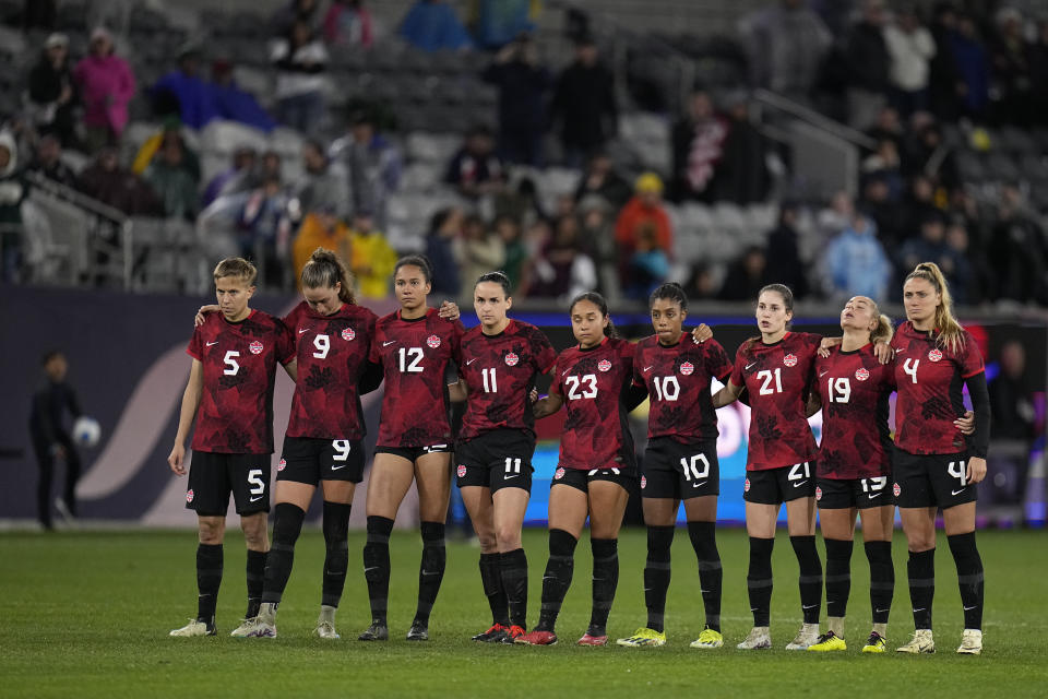 Players for Canada look on during the penalty shootout in a CONCACAF Gold Cup women's soccer tournament semifinal match, Wednesday, March 6, 2024, in San Diego. (AP Photo/Gregory Bull)