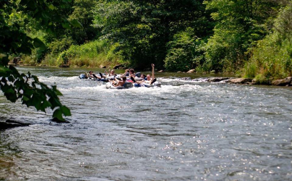 A group of friends from State College go over a small rapid as they float down Spring Creek toward Milesburg on Friday, June 21, 2024.