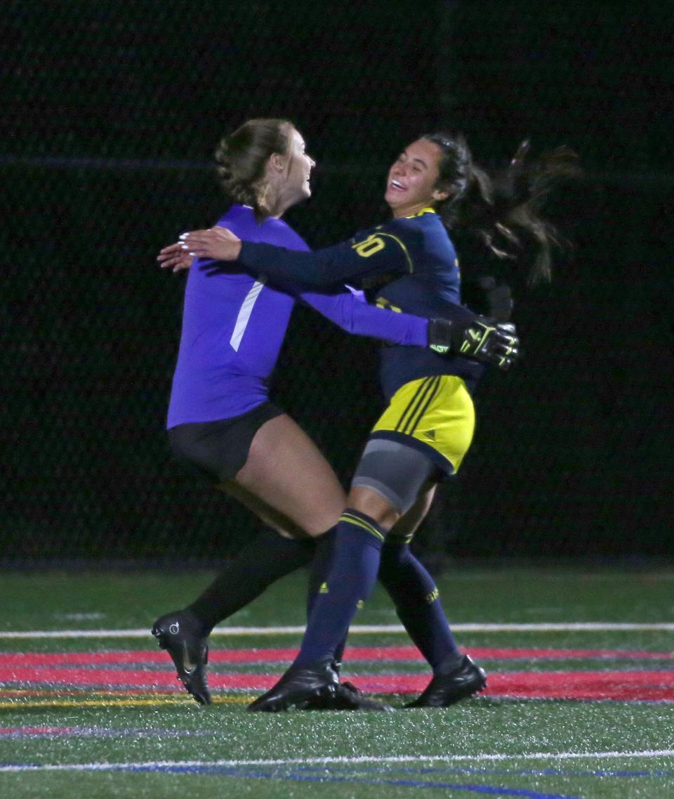 Spencerport goalkeeper Cate Burns and Kendall Mesh start the celebration as the final buzzer sounds giving Spencerport the 3-0 victory over Schroeder.