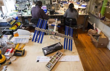 A Little Bits kit and model of the International Space Station is displayed on a work bench at the Little Bits company headquarters in New York April 23, 2014. REUTERS/Brendan McDermid