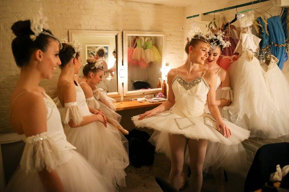 Snow dancers put the finishing touches on their costumes during dress rehearsal for the Nutcracker at the Bama Theatre Wednesday, Dec. 12, 2018. Haley Winegarden gets help from Jennifer Walker. From left are snow dancers Isabella Ellis, Mims McKee and Kathryn Sain. [Staff Photo/Gary Cosby Jr.], 