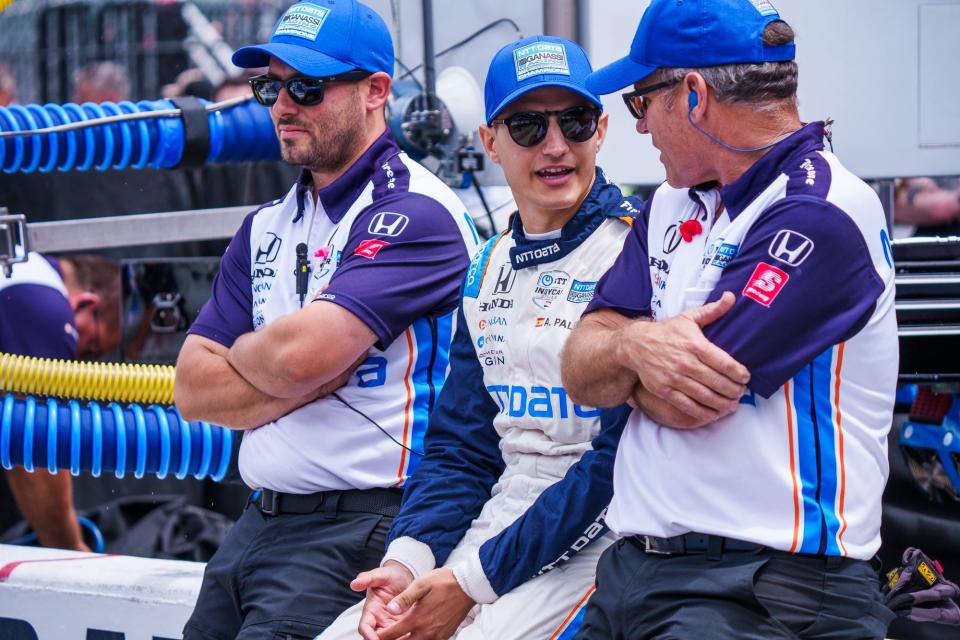 Chip Ganassi Racing driver Álex Palou (10) talks with crew members Friday, May 27, 2022, during Carb Day at Indianapolis Motor Speedway.