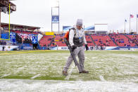 A worker blows snow off the field before the FCS championship NCAA college football game between North Dakota State and James Madison, Saturday, Jan. 11, 2020, in Frisco, Texas. (AP Photo/Sam Hodde)