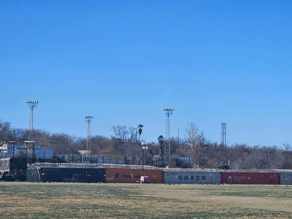 The Texas/Mexico border, barricaded with shipping containers and wire.