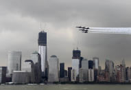 Military aircraft fly in formation in front of the lower Manhattan skyline and the World Trade Center site as seen from Jersey City, N.J., Wednesday, May 23, 2012. Naval vessels ranging from a U.S. amphibious assault ship to a Finnish minelayer are participating in New York City's Fleet Week. (AP Photo/Seth Wenig)