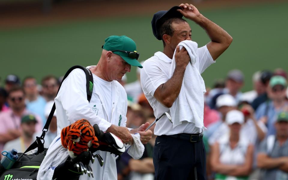 Tiger Woods of the United States and caddie Joe LaCava look on during the first round of the 2023 Masters Tournament at Augusta National Golf Club on April 06, 2023 in Augusta, Georgia - Patrick Smith/Getty Images